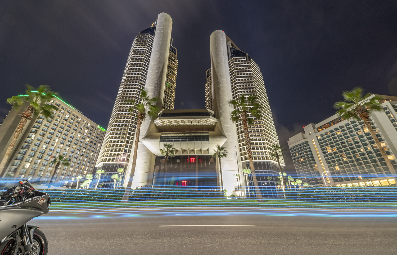 Mirrored Towers: Night Lights Along Ocean Drive